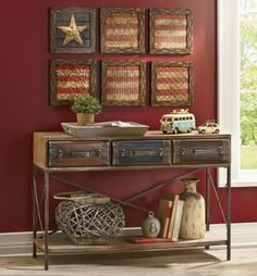 a living room scene with focus on the console table and red wall behind it,