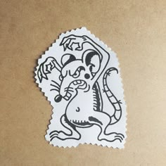 a sticker with a drawing of a rat on it's face and tail