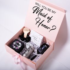 a pink box with some items in it that says will you be my maid of honor?