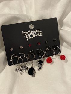 Show your love for My Chemical Romance with this amazing set of 6 pair earrings in silver tone, red and black. Show off your passion with these beautiful jewelry pieces. Made from nickel-free alloy, these earrings are perfect for casual occasions. My Chemical Romance Jewelry, Mcr Earrings, Mcr Bracelet, Mcr Outfits, Mcr Three Cheers, Mcr Merch, Emo Piercings, Three Cheers For Sweet Revenge, Emo Gifts