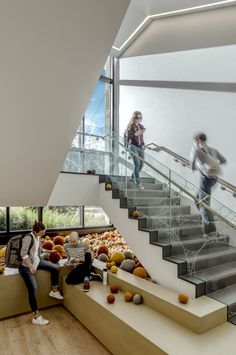 two people are sitting on the stairs and one person is walking up