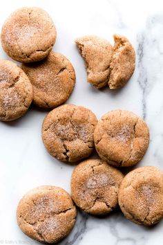 chocolate chip cookies with powdered sugar on a marble countertop, ready to be eaten