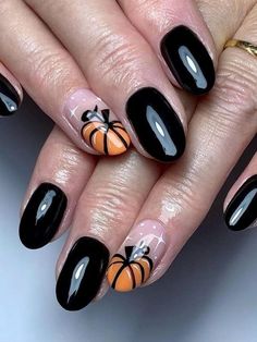 cute pumpkin nails: black nails with pumpkin accent Cute Pumpkin Nails, Pumpkin Nail Designs, Pumpkin Nail Art, Thanksgiving Nail Designs, Thanksgiving Nail, Simple Fall Nails