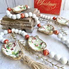 a table topped with white and red beads next to a box filled with ornaments on top of it