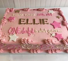 a pink birthday cake with stars on it