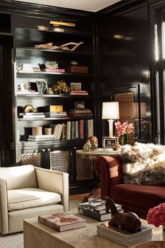 a living room filled with furniture and lots of books