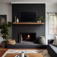 a living room filled with furniture and a fire place in front of a flat screen tv