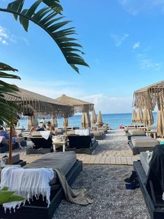 lounge chairs and umbrellas are on the beach