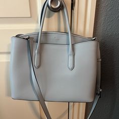 This Stylish Shoulder Bag From Kate Spade Features A Sophisticated Blue Color And A Structured Rectangular Shape. Made From High-Quality Textured Leather, It Includes Sturdy Top Handles And A Detachable Adjustable Shoulder Strap For Versatile Carrying Options. Blue Shoulder Bag, Bags Kate Spade, Stylish Shoulder Bag, Kate Spade Bags, Shoulder Bags, Shoulder Strap, Handles