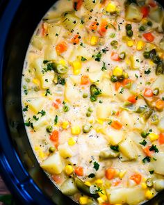 a crock pot filled with potatoes, carrots and broccoli