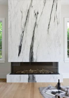 a living room with a large marble fireplace