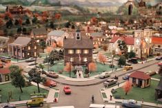 a model town is shown with cars and buildings