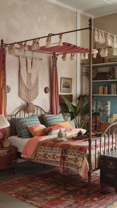 a bedroom with a canopy bed, rugs and bookshelves on the wall