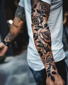 a man's arm with flowers on it