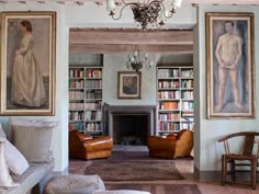 a living room filled with furniture and paintings