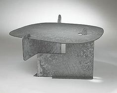 an unusual table made out of concrete on a white background