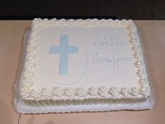 a white cake with a blue cross on it and the words god blocks, thomas james