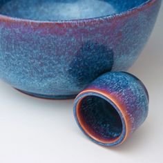 a blue and purple bowl sitting on top of a white table