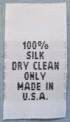 a piece of fabric with words written on it that says 100 % silk or clean only made in usa