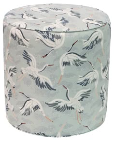 a blue and white ottoman with birds on it