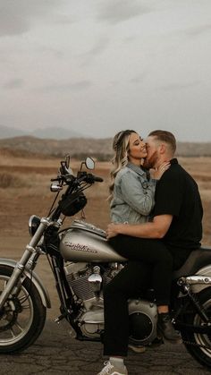 a man and woman sitting on a motorcycle