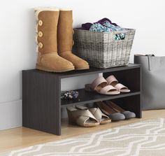 the shoes are lined up on the shelf next to the basket and purse in the room