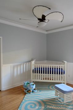 a baby's room with blue and white decor