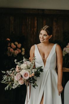 a woman in a white dress holding a bouquet