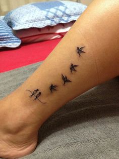 a woman's foot with birds on it and the word love written in black ink