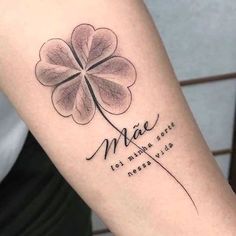 a clover tattoo with the words mae and four leaf clovers on it's arm