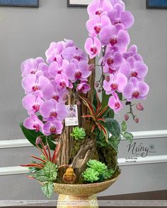 a vase filled with purple flowers on top of a table