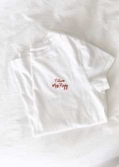 "Gift a custom hand embroidered Mrs. t-shirt to the best bride you know! She can wear it while shopping for their registry, picking out bridesmaid dresses or just while having coffee with her partner-to-be. This is the perfect gift for the next bridal shower you're invited to. Modern brides will love the minimalist design and heartfelt touch that this personalized gift has. This shirt is 100% cotton and hand stitched by me. C U S T O M I Z A T I O N S Shirt Size & Color: Shirts are available in Hand Embroidered Shirt, Bride Tshirt, Having Coffee, Best Bride, Bridal Shirts, Mrs Shirt, Embroidery Tshirt, Personalized Bride, You're Invited