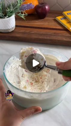 someone is mixing food in a bowl with a spatula