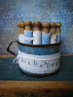 there is a blue and white bucket filled with matchesticks on top of a table