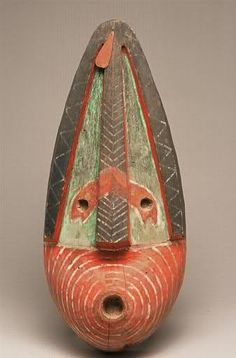 an old wooden vase with painted designs on it's face and bottom, sitting on a white surface