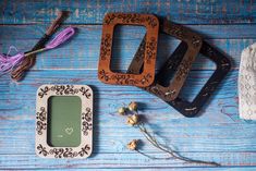 three different types of scissors and other items on a blue wooden table with laces