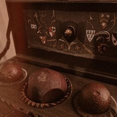 two cakes sitting on top of a table next to a wooden box filled with frosting