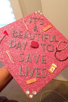 a pink graduation cap that says it's a beautiful day to save lives on it