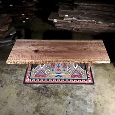 a wooden bench sitting on top of a rug