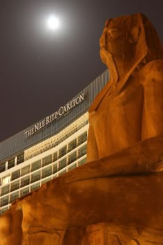 the nite ritz carlton hotel and its statue at night