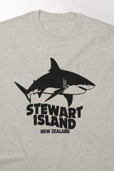 a gray t - shirt with a shark and the words stewart island new zealand on it