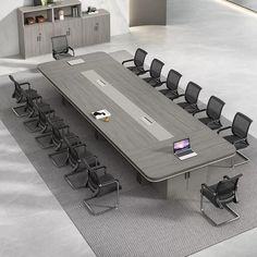 an empty conference table with chairs around it