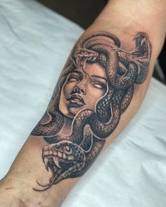 a woman with a snake tattoo on her arm