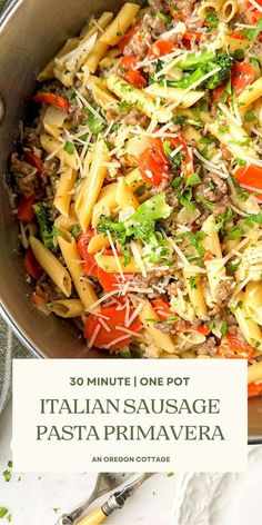 a pan filled with pasta and vegetables on top of a table