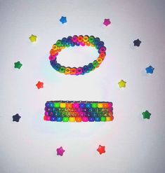 a rainbow colored keyboard surrounded by stars and confetti on a white background with space for text