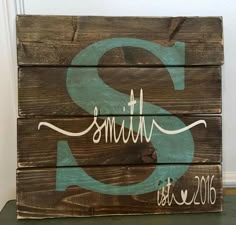 a wooden sign with the letter s painted on it