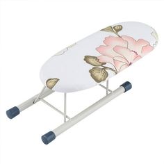 an ironing board with pink flowers on it