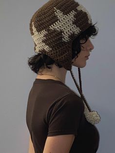 a woman wearing a brown and white knitted hat