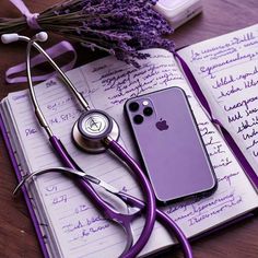 a notepad, stethoscope and phone on a table with lavender flowers