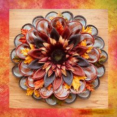 a close up of a flower on a wooden surface with text overlay that reads, fall wreath